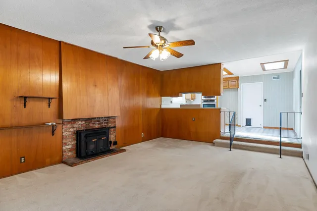 a view of an empty room with a kitchen