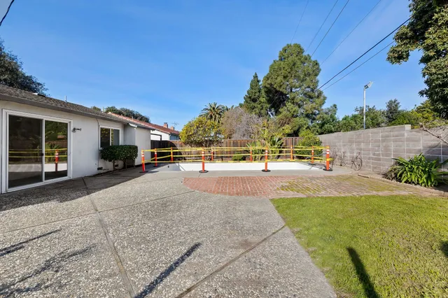 a view of a backyard with a fence
