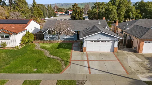 an aerial view of residential houses with outdoor space
