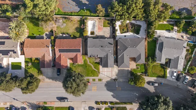 an aerial view of residential houses with outdoor space