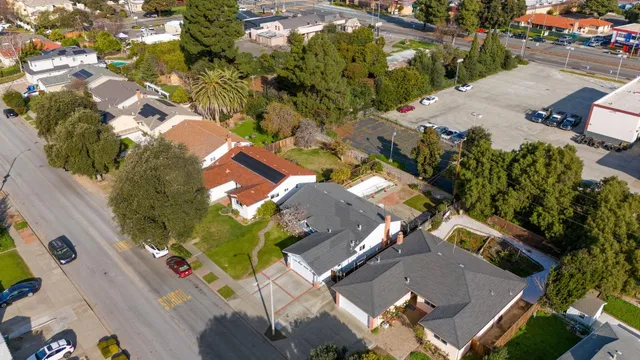 an aerial view of a house with a yard basket ball court and outdoor seating