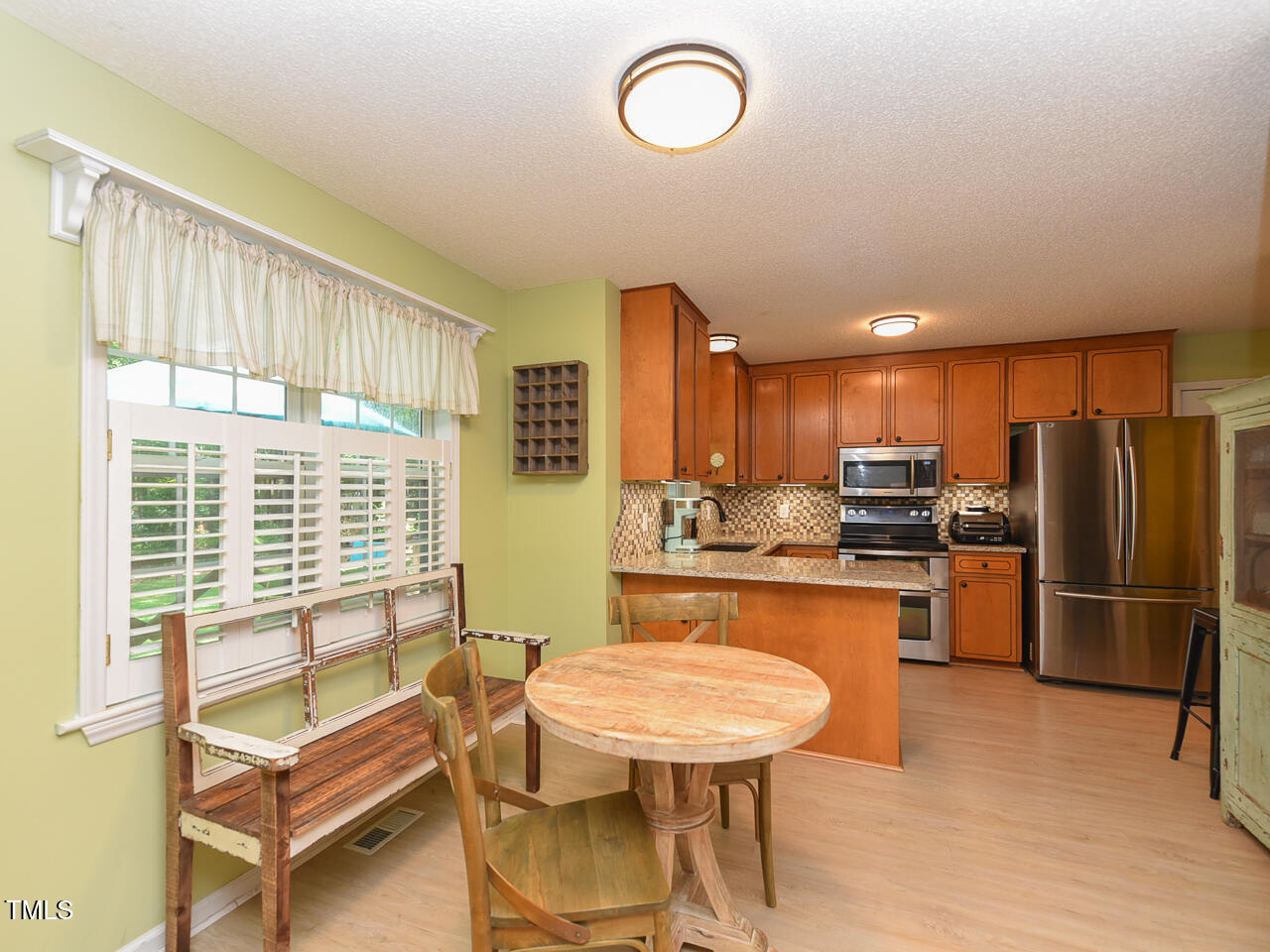 125 Walker Run Selma, NC 27576 - Photo 11 of 47 a kitchen with refrigerator a sink and chairs