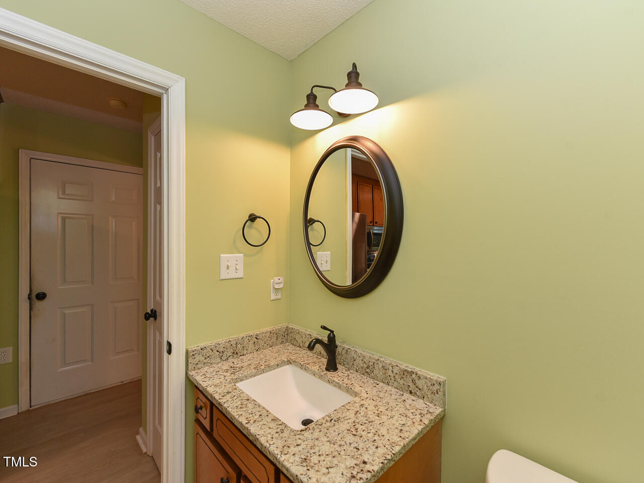 125 Walker Run Selma, NC 27576 - Photo 15 of 47 a bathroom with a granite countertop sink and a mirror