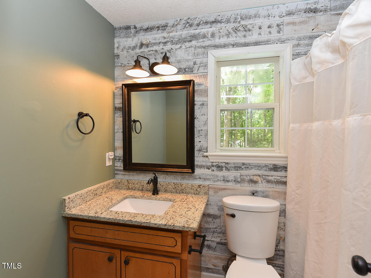 125 Walker Run Selma, NC 27576 - Photo 29 of 47 a bathroom with a granite countertop sink toilet and mirror