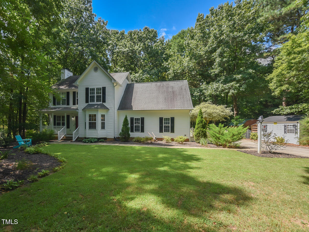 125 Walker Run Selma, NC 27576 - Photo 4 of 47 a front view of a house with a garden