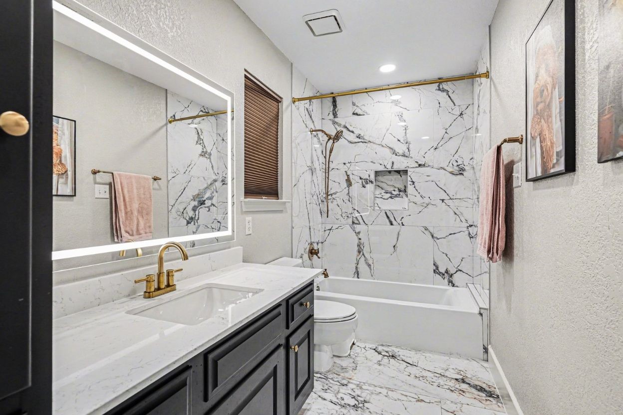 17519 Hawkin Lane Tomball, TX 77377 - Photo 34 of 48 Updated secondary bath showcases a modern vanity, elegant fixtures, and a beautifully tiled tub/shower.