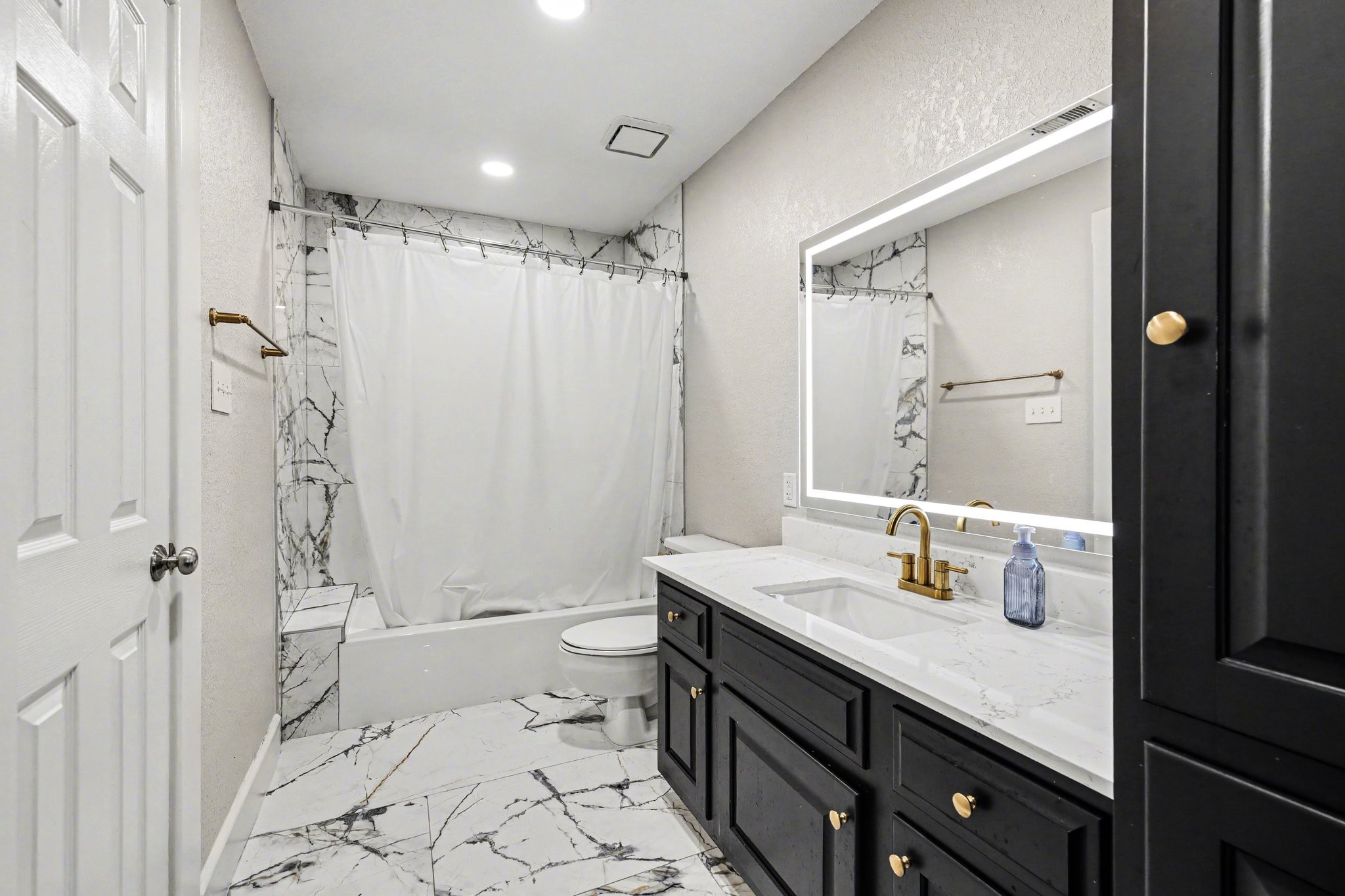 17519 Hawkin Lane Tomball, TX 77377 - Photo 36 of 48 Secondary bathroom with ample storage and a combination tub and shower.