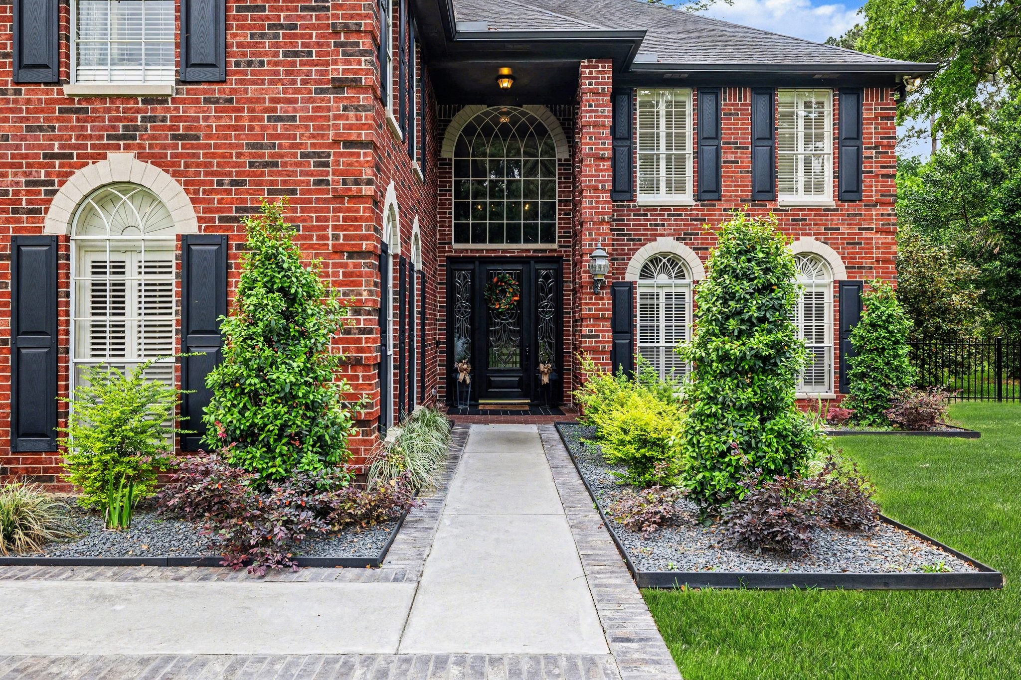 17519 Hawkin Lane Tomball, TX 77377 - Photo 6 of 48 Inviting front entrance featuring a manicured walkway, lush landscaping, and a stunning front door framed by classic brick architecture.