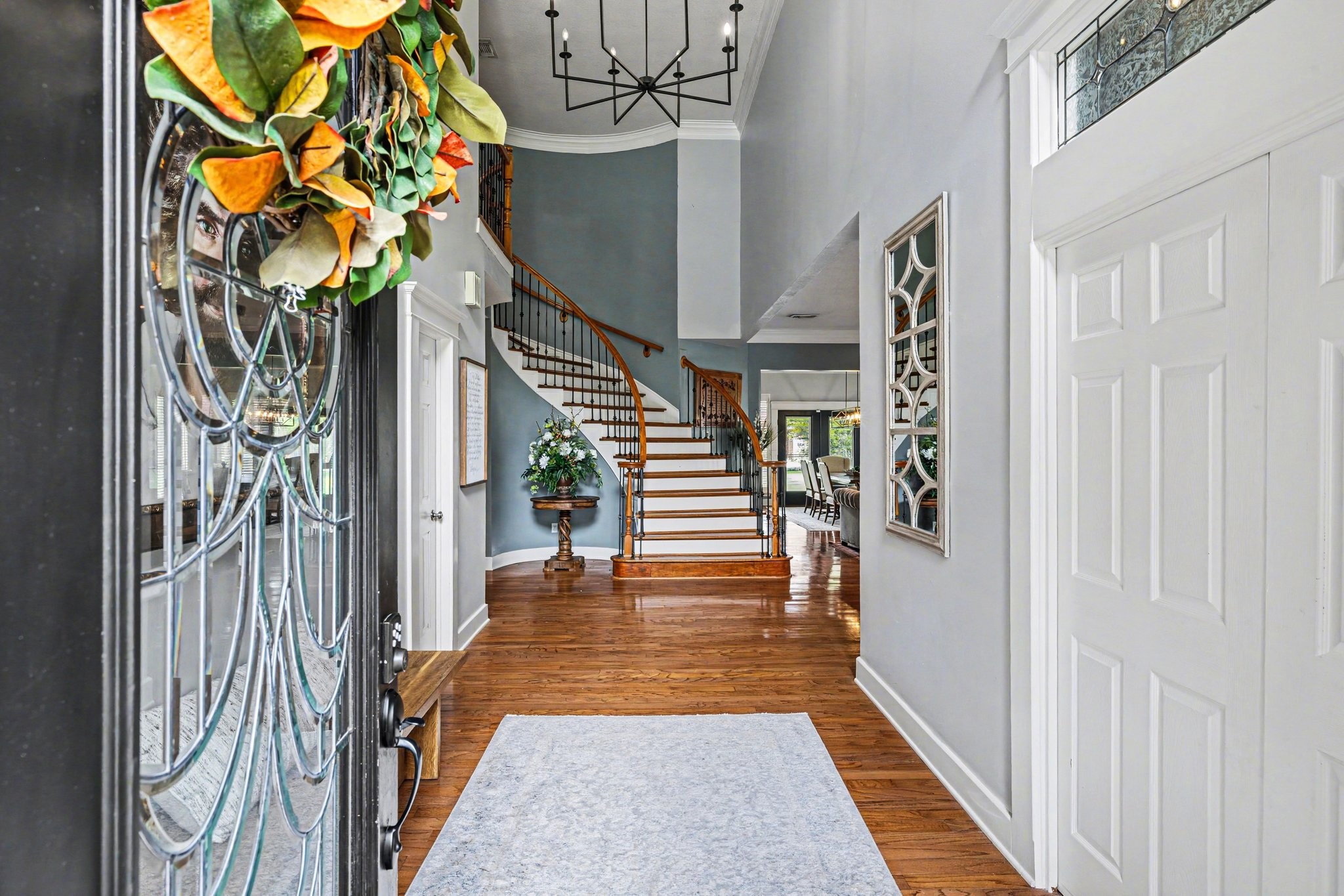 17519 Hawkin Lane Tomball, TX 77377 - Photo 7 of 48 Step inside to a beautiful entry showcasing rich wood floors, soaring ceilings, and a dramatic curved staircase.