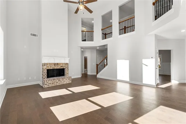 a view of a livingroom with wooden floor and a fireplace