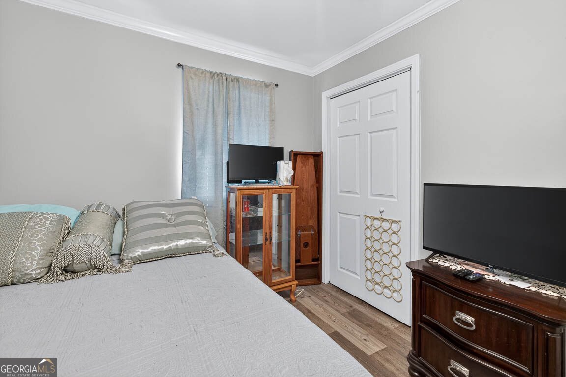 33 Warren Avenue Waverly, GA 31565 - Photo 15 of 63 a bedroom with bed and flat screen tv