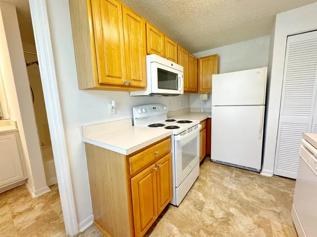 a kitchen with a refrigerator sink and a stove