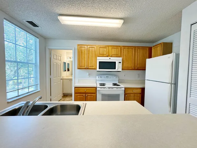 a kitchen with stainless steel appliances a refrigerator sink and cabinets