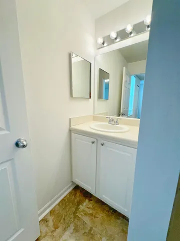 a bathroom with a sink toilet vanity and mirror