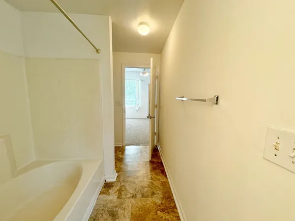 a bathroom with a tub and shower