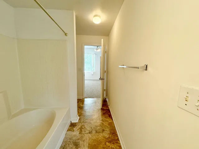 a bathroom with a tub and shower