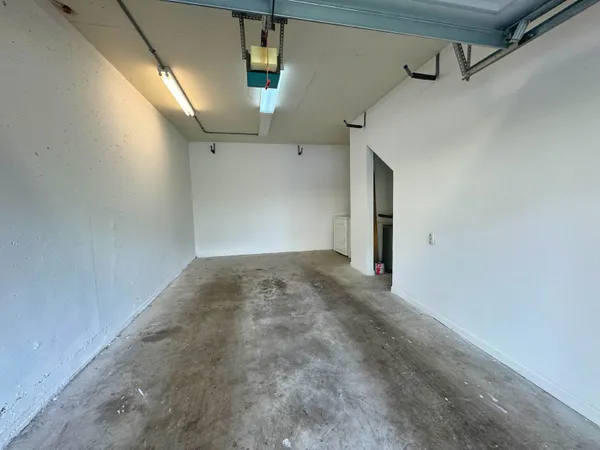 a view of a swimming pool with a lawn chairs and palm tree