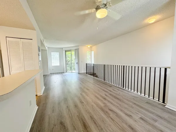 a view of a room with wooden floor