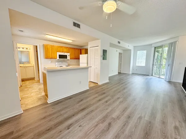 a view of a kitchen cabinets and wooden floor