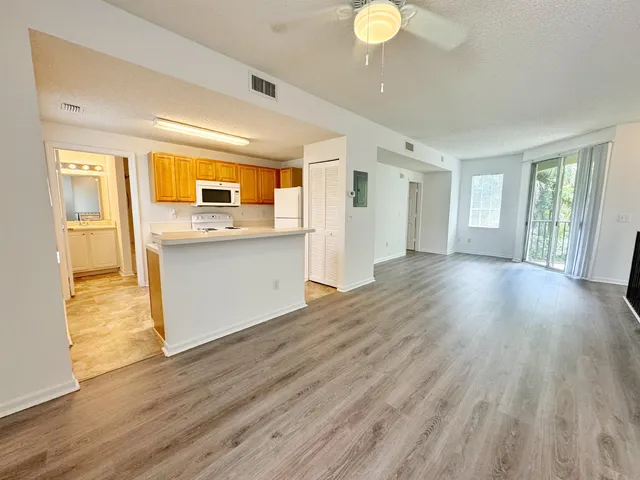 a view of a kitchen cabinets and wooden floor