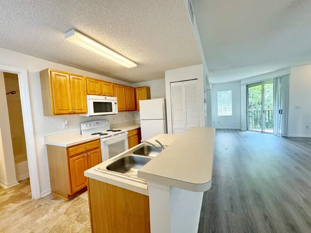 a kitchen that has a sink and a stove top oven