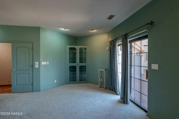 a kitchen with a sink window and cabinets