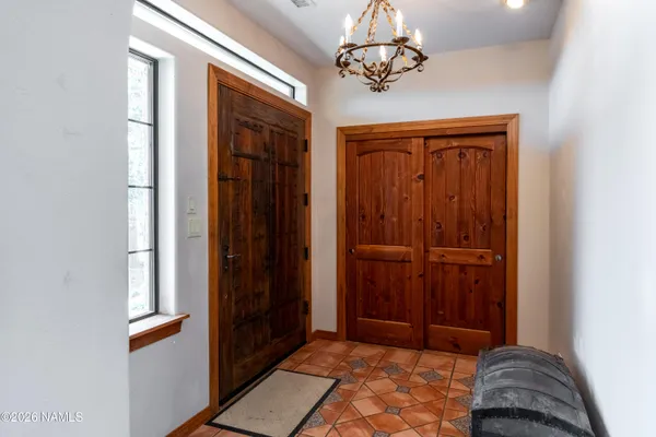 a kitchen with stainless steel appliances kitchen island granite countertop a sink refrigerator and cabinets