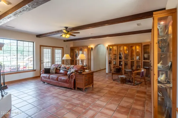 a living room with furniture a chandelier and a dining table