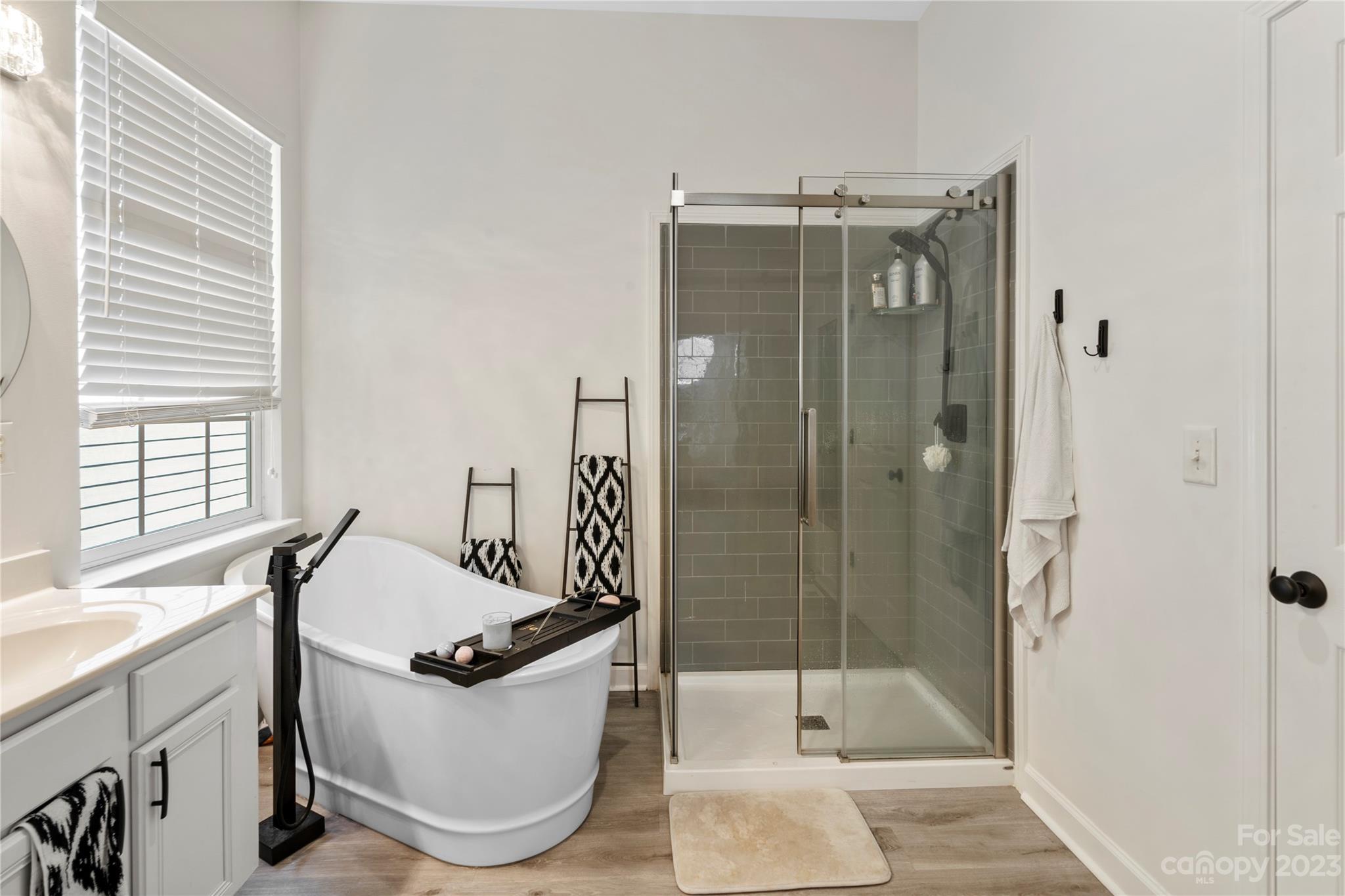 8315 Camberly Road Huntersville, NC 28078 - Photo 17 of 31 a bathroom with a tub a mirror and a shower