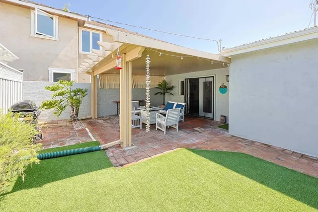 a view of an house with backyard porch and sitting area