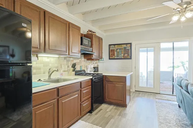 a kitchen with a sink stove and cabinets