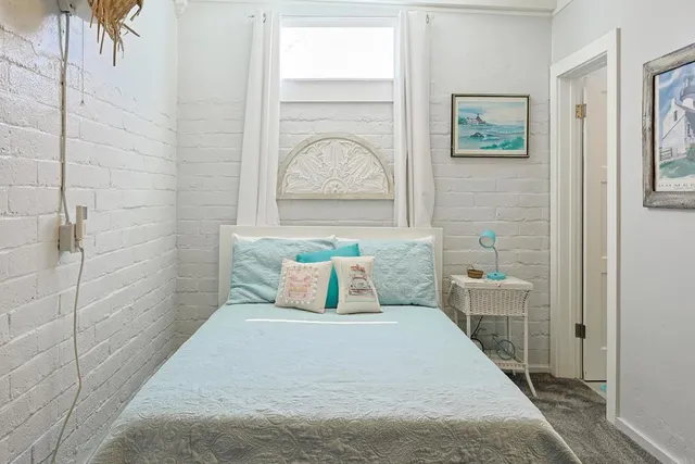 a bedroom with a bed and a painting on the wall