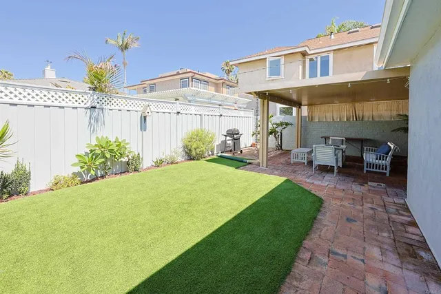 a view of a patio with table and chairs and potted plants
