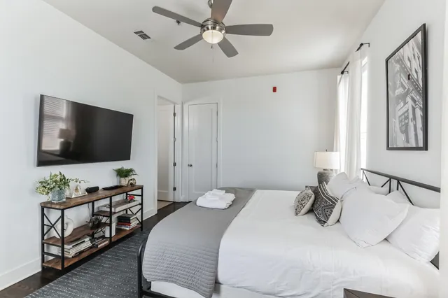 a bedroom with a bed and a flat screen tv