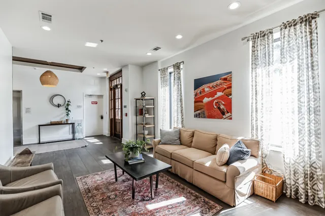 a living room with furniture and a rug