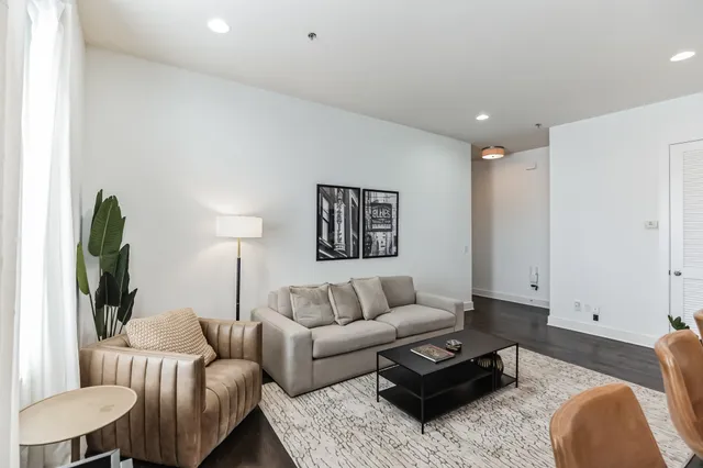 a living room with furniture and a lamp