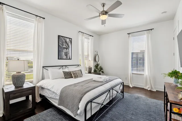 a bedroom with a large bed and a chandelier
