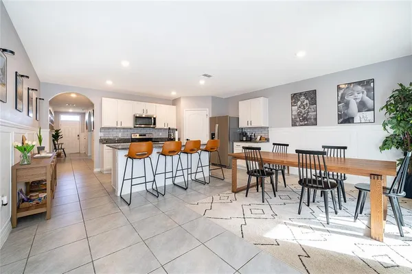 a living room with lots of furniture and kitchen view