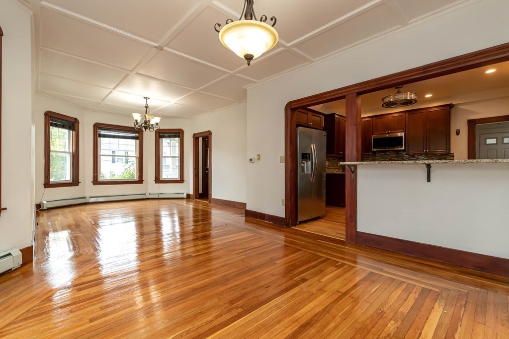 1 May Court Methuen, MA 01844 - Photo 11 of 40 a view of an empty room with window and wooden floor