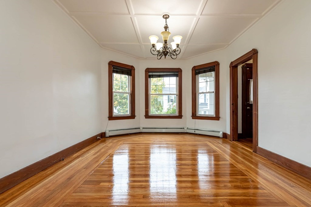 1 May Court Methuen, MA 01844 - Photo 13 of 40 a view of an empty room with wooden floor and a window
