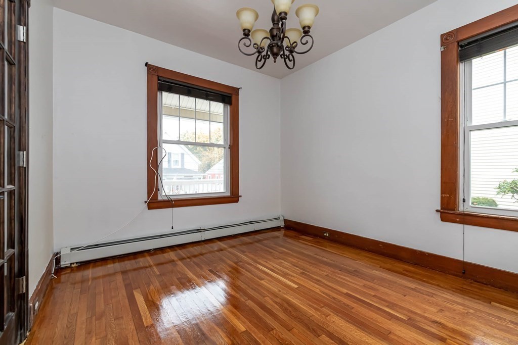1 May Court Methuen, MA 01844 - Photo 14 of 40 a view of an empty room with wooden floor and a window