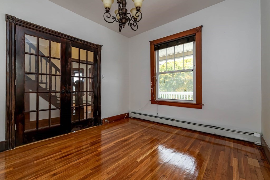 1 May Court Methuen, MA 01844 - Photo 15 of 40 a view of an empty room with a window and wooden floor