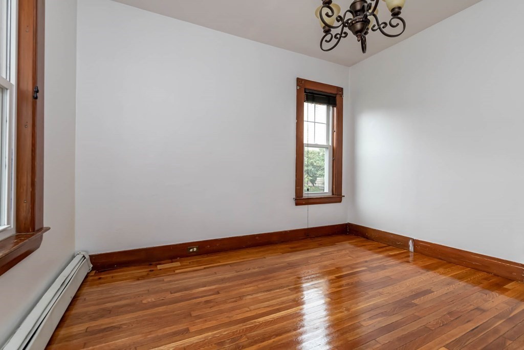 1 May Court Methuen, MA 01844 - Photo 16 of 40 a view of an empty room with wooden floor and a window