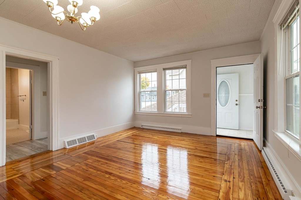 1 May Court Methuen, MA 01844 - Photo 25 of 40 a view of empty room with wooden floor and fan