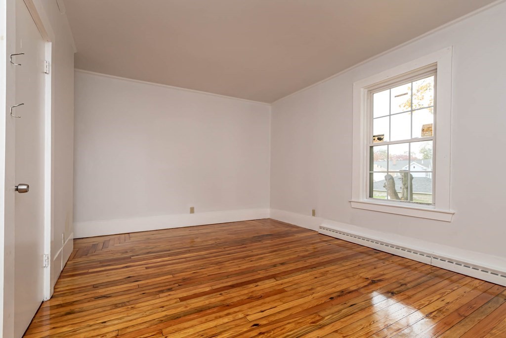 1 May Court Methuen, MA 01844 - Photo 33 of 40 a view of an empty room with wooden floor and a window