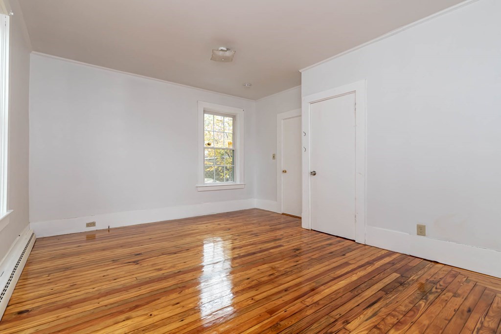 1 May Court Methuen, MA 01844 - Photo 35 of 40 a view of empty room with wooden floor and fan
