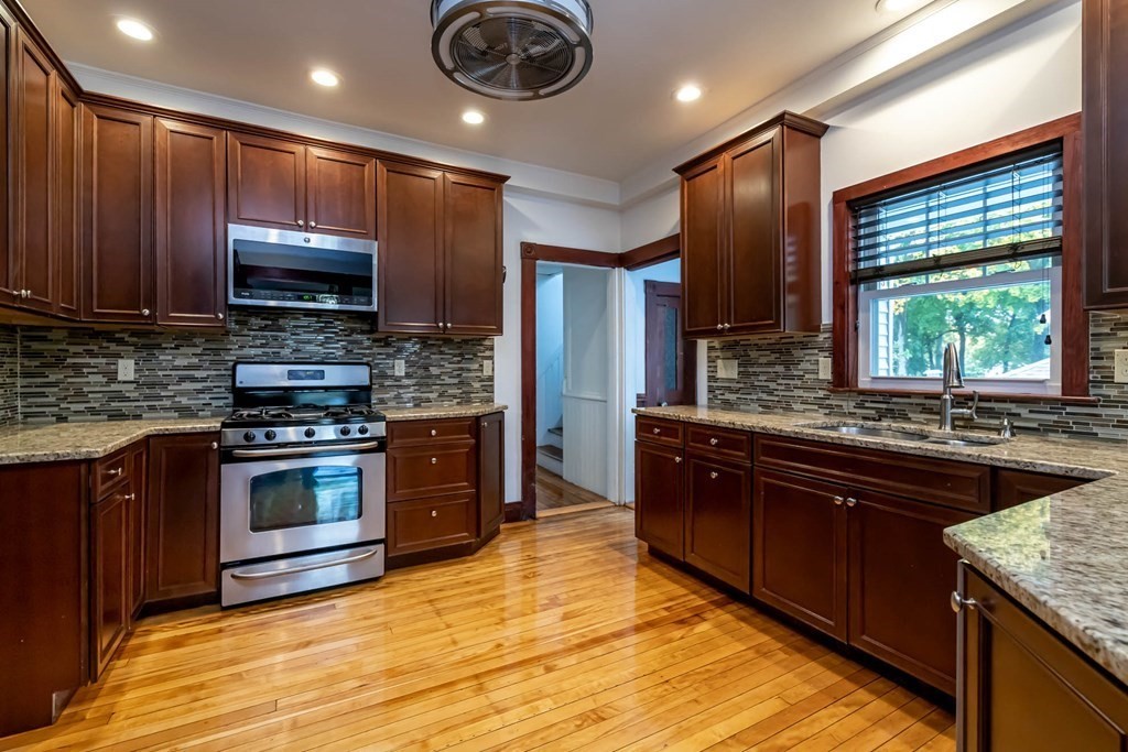 1 May Court Methuen, MA 01844 - Photo 9 of 40 a kitchen with stainless steel appliances granite countertop wooden cabinets a sink dishwasher a stove and a refrigerator