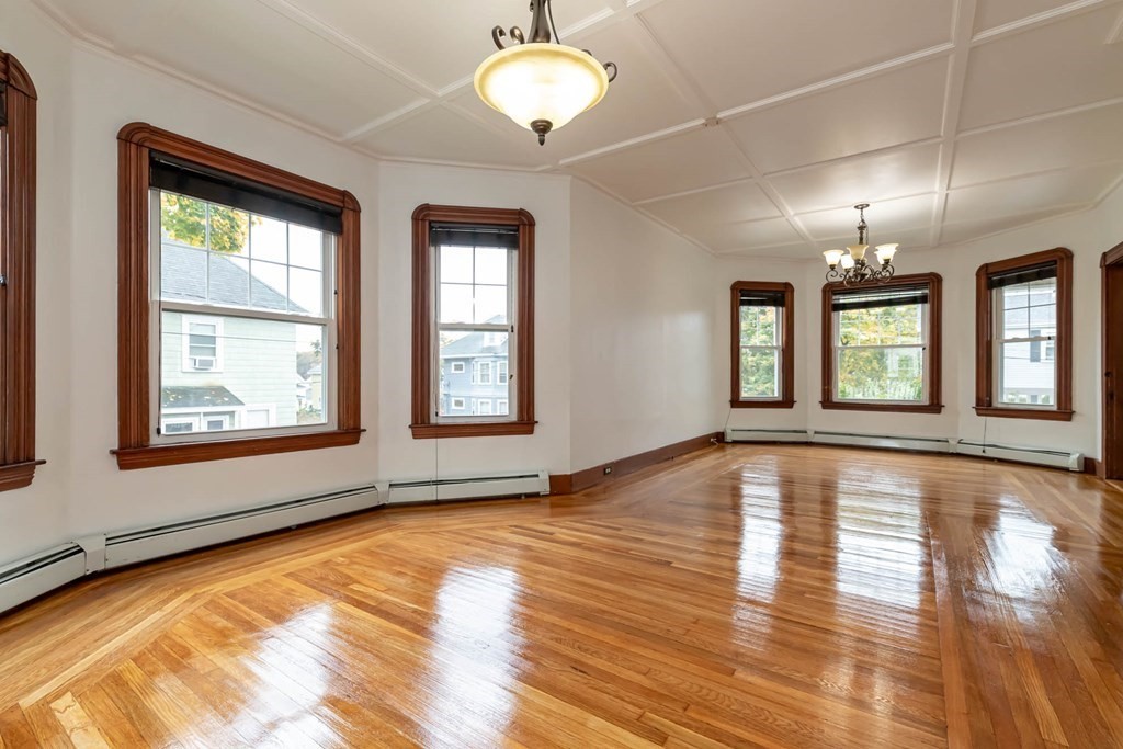 1 May Court Methuen, MA 01844 - Photo 10 of 40 a view of an empty room with window and wooden floor