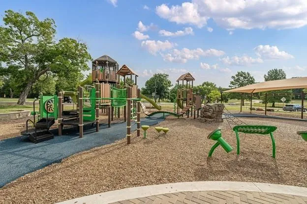 a view of a park with swings and slides