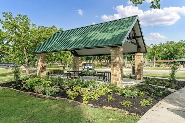 a view of the patio with a table and chairs under an umbrella